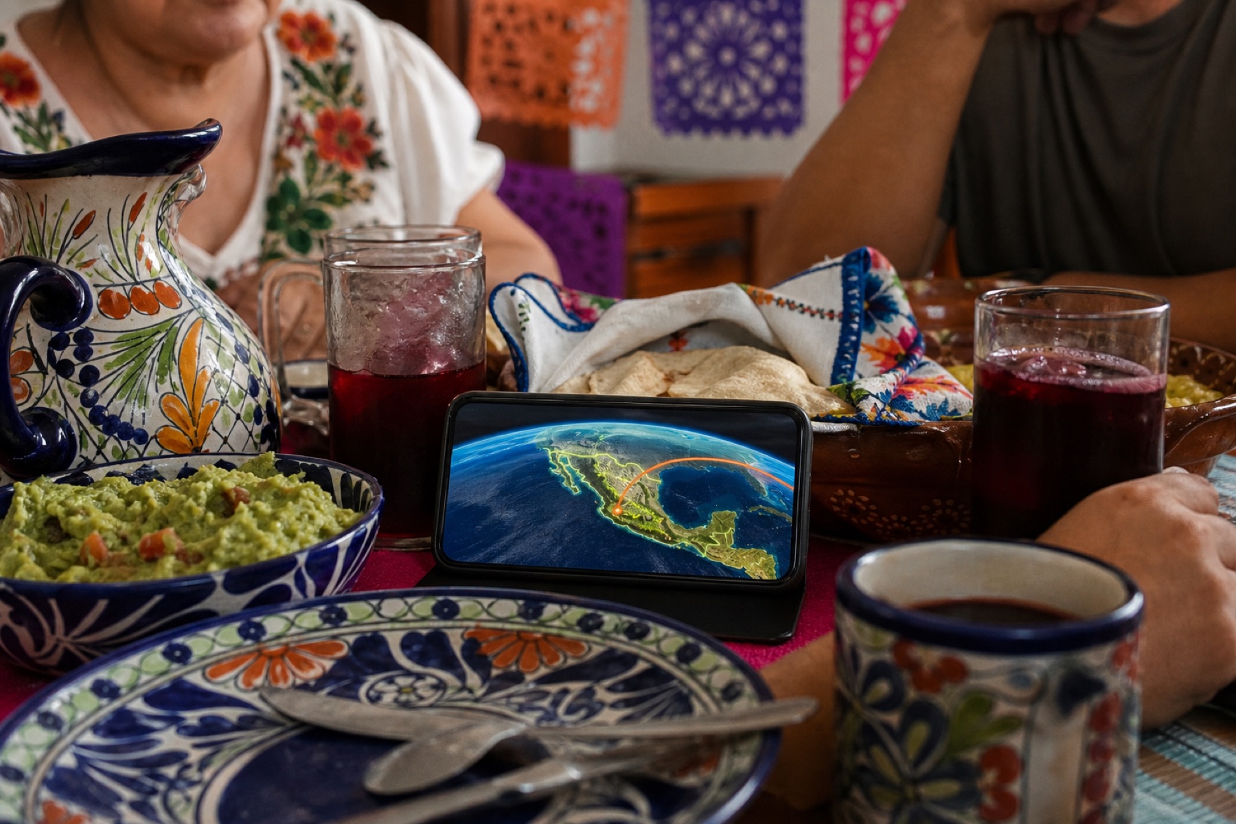 Sunday family table in Mexico with Talavera dishes and a phone showing a 3D globe travel recap centered on Mexico